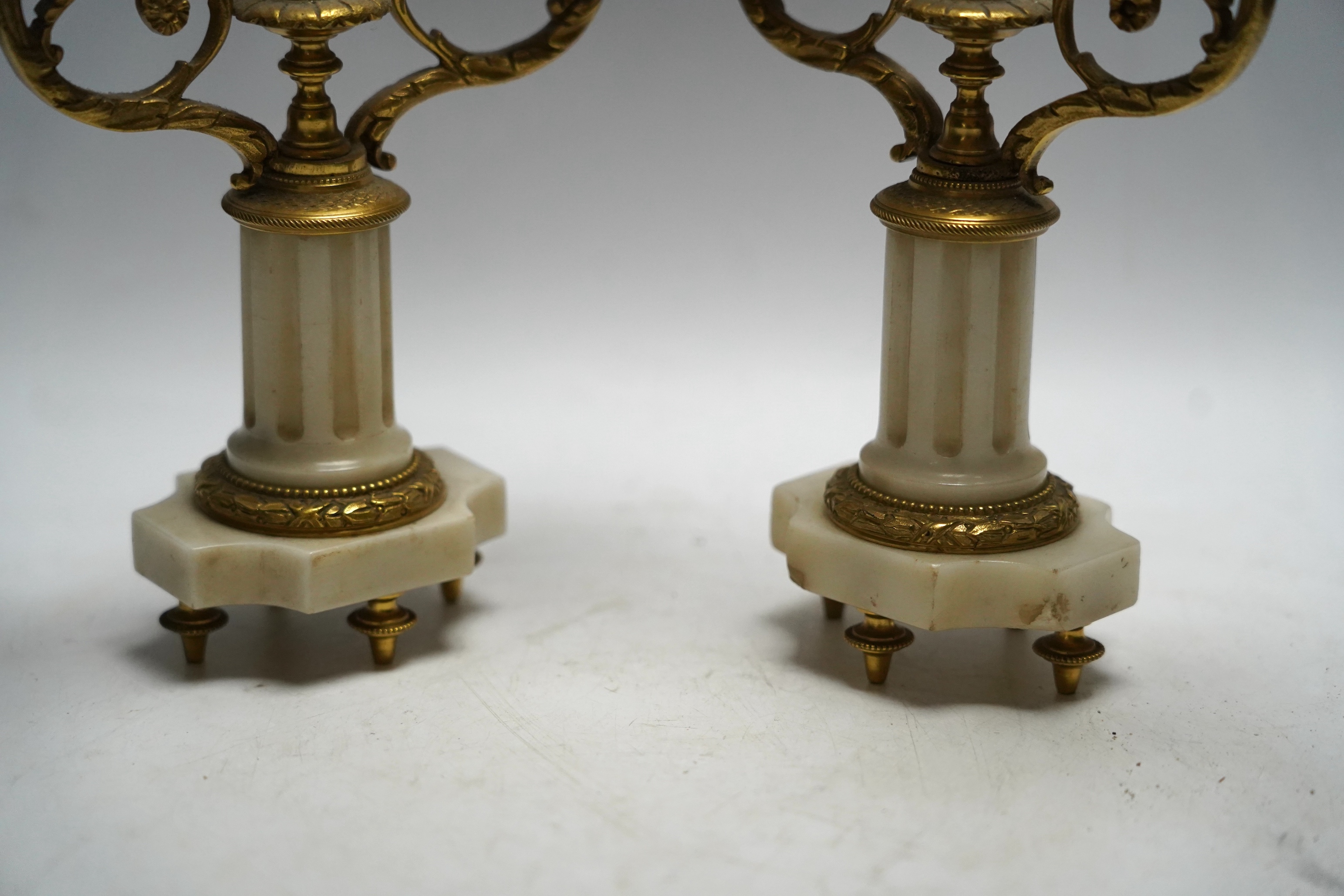 A pair of late 19th century alabaster and gilt metal two light candelabra, 22cm. Condition - good